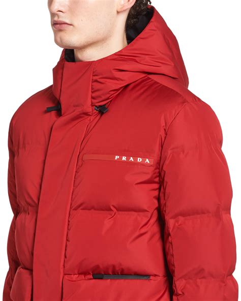 Prada puffer jacket red with fur hood .